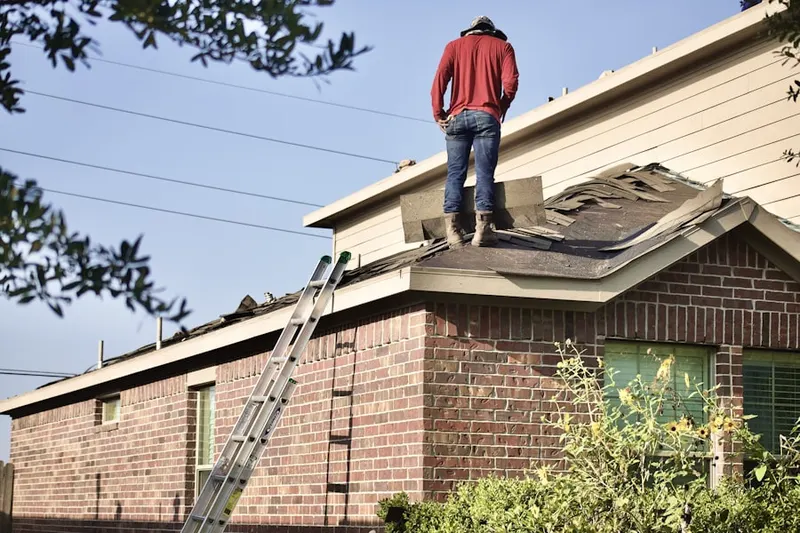 Professional roofer working on a residential roof in Dewey Park